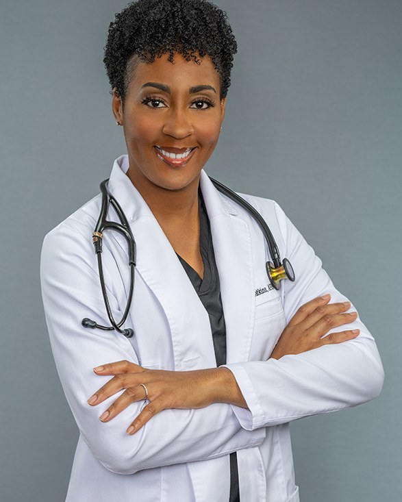 Peta Watkins, MSN, APRN, in a white coat with a stethoscope